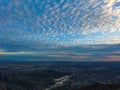 Aerial view of the city at sunset with blue skies and clouds