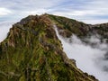 Breathtaking hiking trail with a view of a beautiful mountain landscape above the clouds of Madeira Island - Green mountain Royalty Free Stock Photo