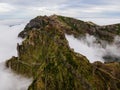 Breathtaking hiking trail with a view of a beautiful mountain landscape above the clouds of Madeira Island - Green mountain Royalty Free Stock Photo