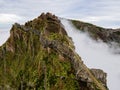 Breathtaking hiking trail with a view of a beautiful mountain landscape above the clouds of Madeira Island - Green mountain Royalty Free Stock Photo