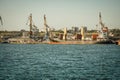 View from afar on cranes and ships in the port of Berdyansk. Royalty Free Stock Photo
