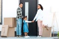 View of african american family looking at camera while standing in front of door of new house Royalty Free Stock Photo