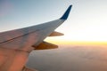 View from airplane on the aircraft white wing flying over desert landscape in sunny morning. Air travel and transportation concept Royalty Free Stock Photo