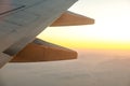 View from airplane on the aircraft white wing flying over desert landscape in sunny morning. Air travel and transportation concept Royalty Free Stock Photo