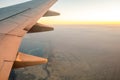 View from airplane on the aircraft white wing flying over desert landscape in sunny morning. Air travel and transportation concept Royalty Free Stock Photo