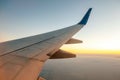 View from airplane on the aircraft white wing flying over desert landscape in sunny morning. Air travel and transportation concept Royalty Free Stock Photo