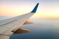 View from airplane on the aircraft white wing flying over ocean landscape in sunny morning. Air travel and transportation concept Royalty Free Stock Photo