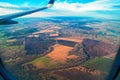 Beautiful landscape of fields with a bird`s-eye view. Wing Through Plane passenger Window. Panoramic view. Royalty Free Stock Photo