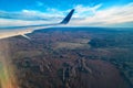 Beautiful landscape of forests and fields with a bird`s-eye view. Wing Through Plane passenger Window. Panoramic view. Royalty Free Stock Photo