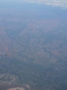 View from airplane at clouds, river under clouds