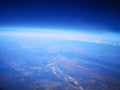 View from airplane at clouds, river under clouds