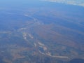 View from airplane at clouds, river under clouds