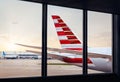 View of airplane fuselage tail through window at airport Royalty Free Stock Photo