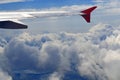 View from airplane illumination above the clouds. Wing of plane above cloudy sky in sunny day. Concept of travel freedom