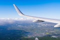 View of airplane white wing flying in blue sky over clouds. Royalty Free Stock Photo