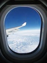 View from an airplane window above the clouds. Royalty Free Stock Photo