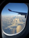 Beautiful Clouds and Ocean Seen through Airplane Window Royalty Free Stock Photo