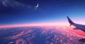 view from airplane window, blue sky with moon and stars above the clouds at night Royalty Free Stock Photo