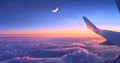 view from airplane window, blue sky with moon and stars above the clouds at night Royalty Free Stock Photo