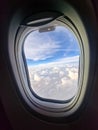 view from airplane window clouds outside vertical shot Royalty Free Stock Photo