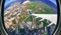 View from airplane window on fields and mountains Royalty Free Stock Photo