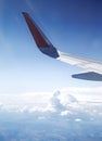 View from the airplane window. Airplane flying above the clouds in the sky