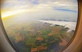 View from airplane window on green fields and clouds in Rome Royalty Free Stock Photo