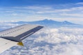 View from the airplane window of the Kilimanjaro volcano in the white clouds in Tanzania, Africa Royalty Free Stock Photo