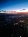 View from an airplane window at night of a city with many lights Royalty Free Stock Photo