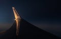 View through an airplane window onto the wing of an Ryanair Boeing 737-800 airplane with winglets in flight during sunset