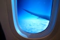 View from airplane window with sky and white clouds in a blue window Royalty Free Stock Photo