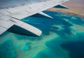 View from an airplane window to the Red Sea reefs and settlements on a deserted shore, Egypt