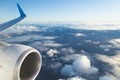 View from airplane window and the wing with sky over fluffy clouds. Flying and traveling concept background Royalty Free Stock Photo