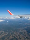 View from airplane windows from passenger, beautiful cloud group, blue sky and landscape. Wing aircraft in altitude during flight. Royalty Free Stock Photo