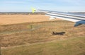 View of airplane wing, Shadow of the plane on the ground during landing, seen from the plane window Royalty Free Stock Photo
