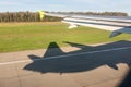 View of airplane wing, Shadow of the plane on the ground during landing, seen from the plane window Royalty Free Stock Photo