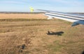 View of airplane wing, Shadow of the plane on the ground during landing, seen from the plane window Royalty Free Stock Photo