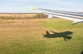 View of airplane wing, Shadow of the plane on the ground during landing, seen from the plane window Royalty Free Stock Photo