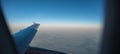 View of airplane wing through window. Flying above the earth Royalty Free Stock Photo