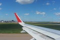 View of the airport and aircraft, blue sky and clouds from the passenger airliner illuminator. Royalty Free Stock Photo
