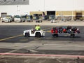 View of airport baggage handlers transporting luggage