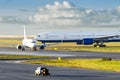 View at the airport with a large aircraft landed, and a small plane departing taxiing for takeoff. Royalty Free Stock Photo