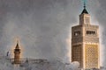 View of the Al-Zaytuna Mosque and the skyline of Tunis at dawn.