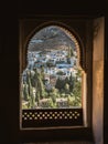 View of the Albaicin district of Granada, Spain, from an arched window in the Alhambra palace Royalty Free Stock Photo