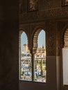 View of the Albaicin district through the windows in the Alhambra palace of Granada, Andalusia, Arabic carved stone arabesque Royalty Free Stock Photo