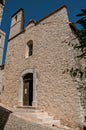 View alley and church with stone steeple tower in Saint-Paul-de-Vence.