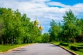 View of alley leading to small modern Orthodox church in Russia