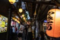 View of the alley at Omoide Yokocho with lantern in the foreground written Japanese word. Landscape Orientation