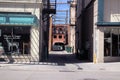 View of Alleyway Shadows Sunny Day Fire Escape Transformers Awnings Historic Buildings