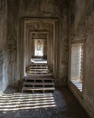 View along a corridor at Angkor wat. Originally constructed in the early 12th century, the ruins are a huge tourist attraction as Royalty Free Stock Photo